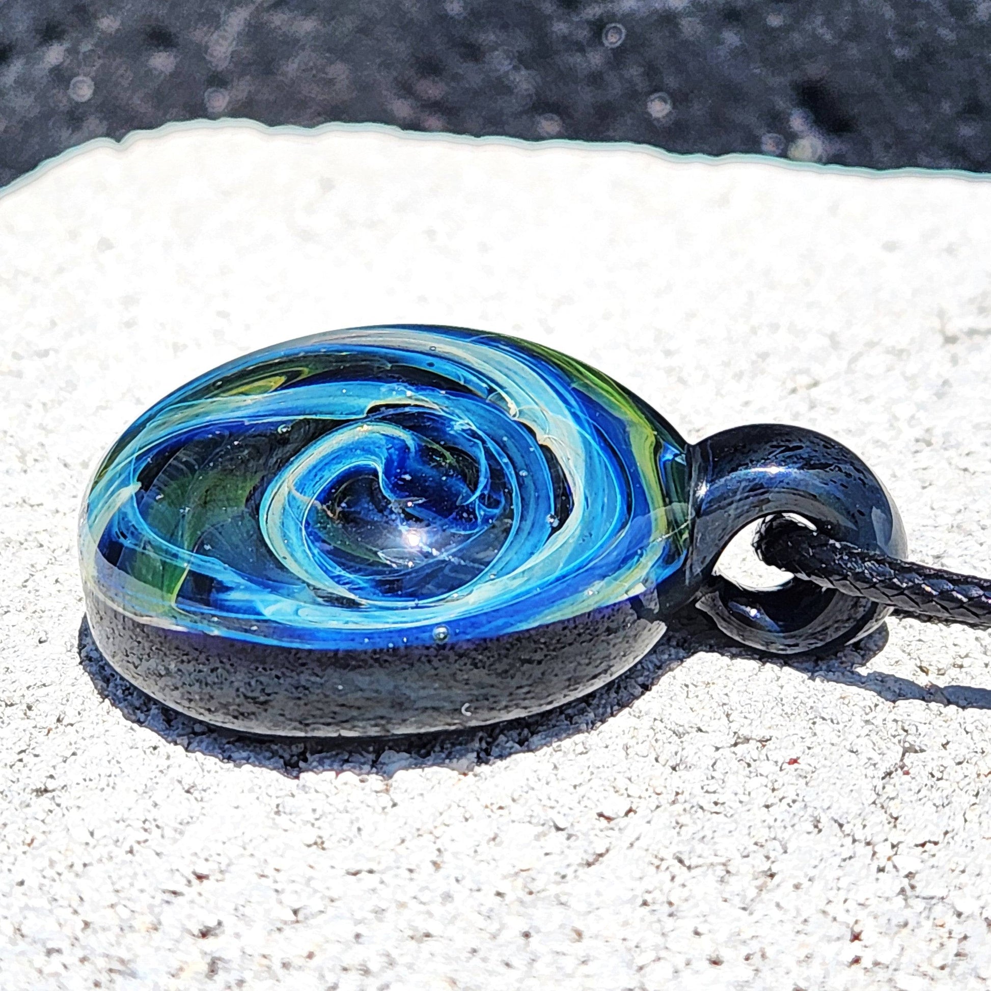 Low-angle view of Heady Glass Pendant showing intricate galaxy swirl design in borosilicate glass, ideal for unique jewelry lovers.