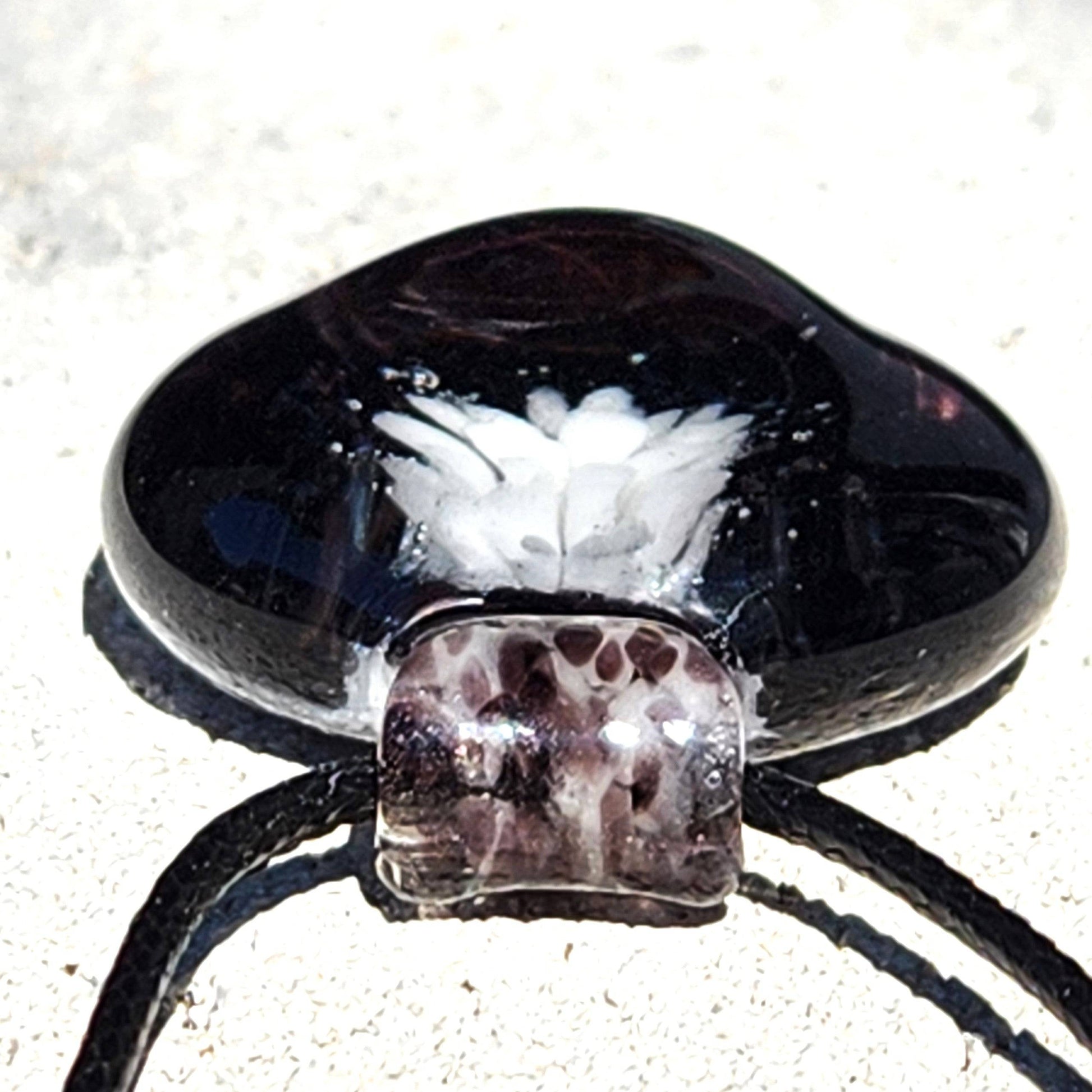 Side view of Heady Blown Glass Pendant showing domed shape and intricate white floral detail, part of handmade glass pendants collection.