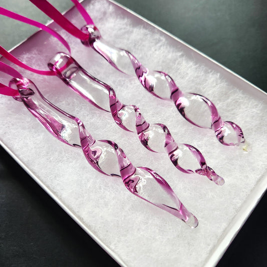 Set of 3 purple spiral glass suncatchers in a gift box with white padding, ready for gifting as unique outdoor ornaments.