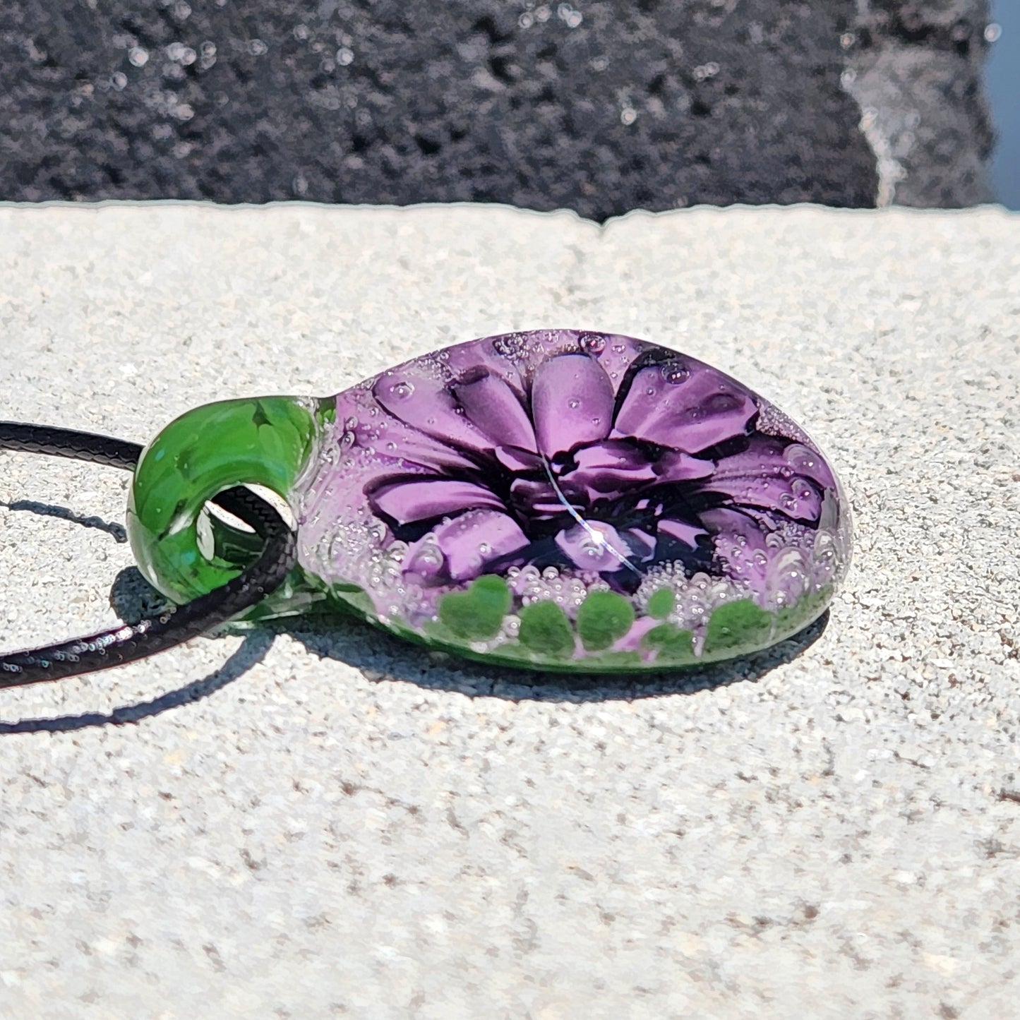 Handmade Borosilicate Glass Pendant: Purple and Black on a Green Background