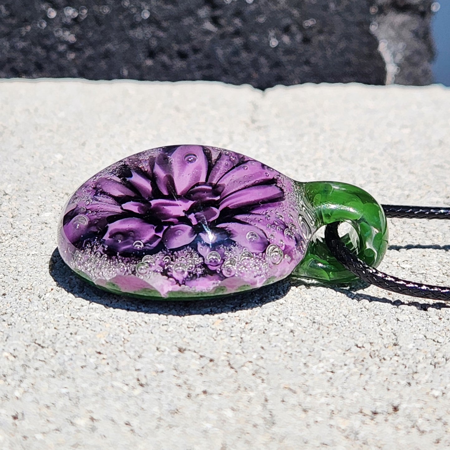 Handmade Borosilicate Glass Pendant: Purple and Black on a Green Background
