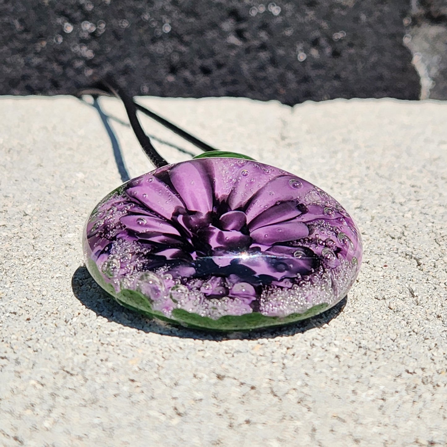 Handmade Borosilicate Glass Pendant: Purple and Black on a Green Background