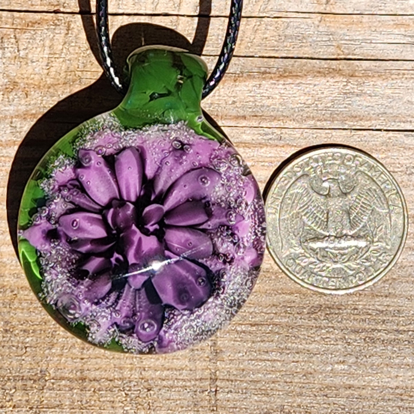 Handmade Borosilicate Glass Pendant: Purple and Black on a Green Background