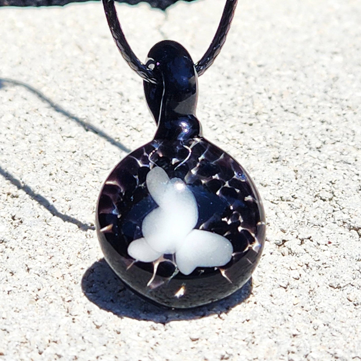 Handmade black glass pendant with a white butterfly motif and crackle effect, part of the Small Black and White Glass Pendant collection.