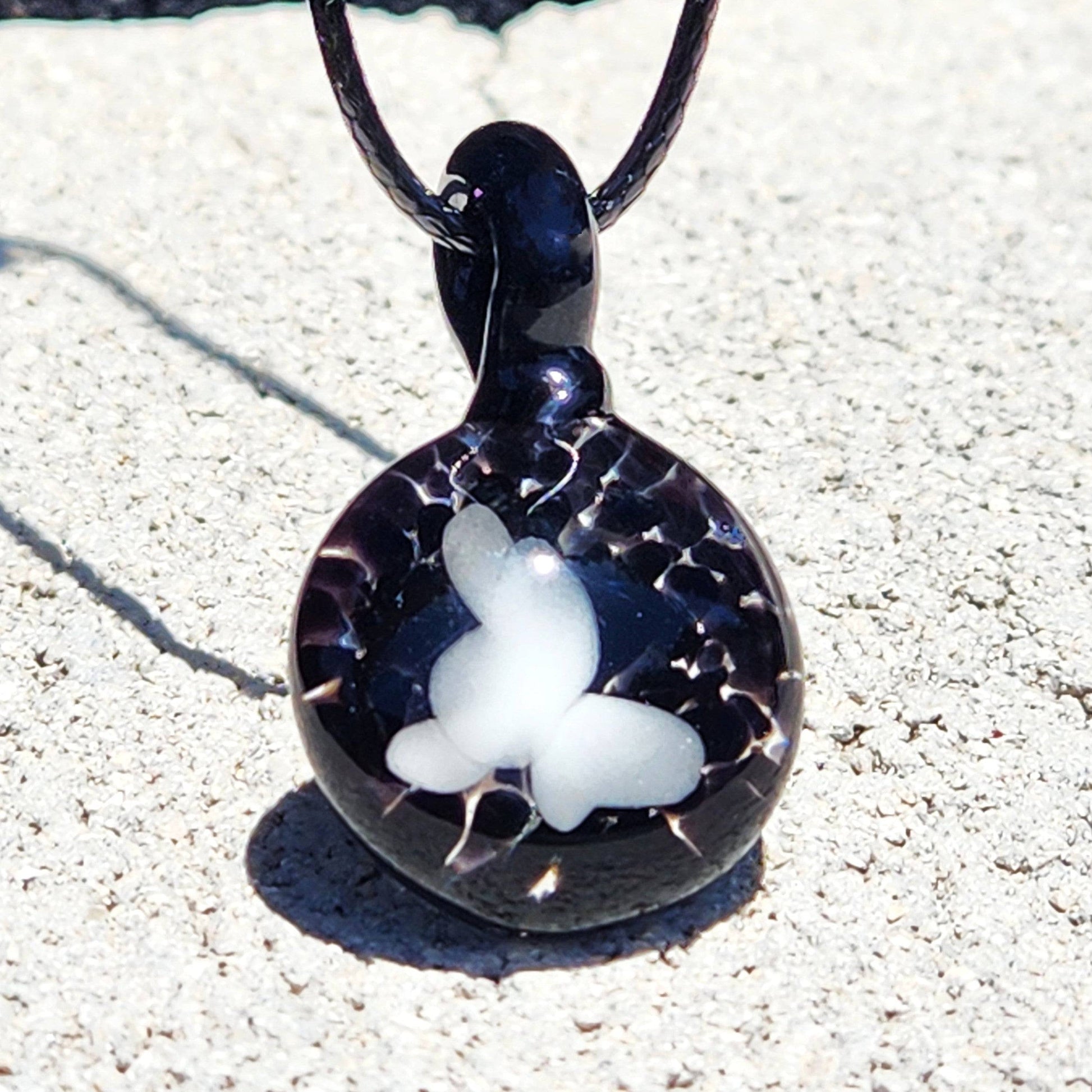 Handmade black glass pendant with a white butterfly motif and crackle effect, part of the Small Black and White Glass Pendant collection.