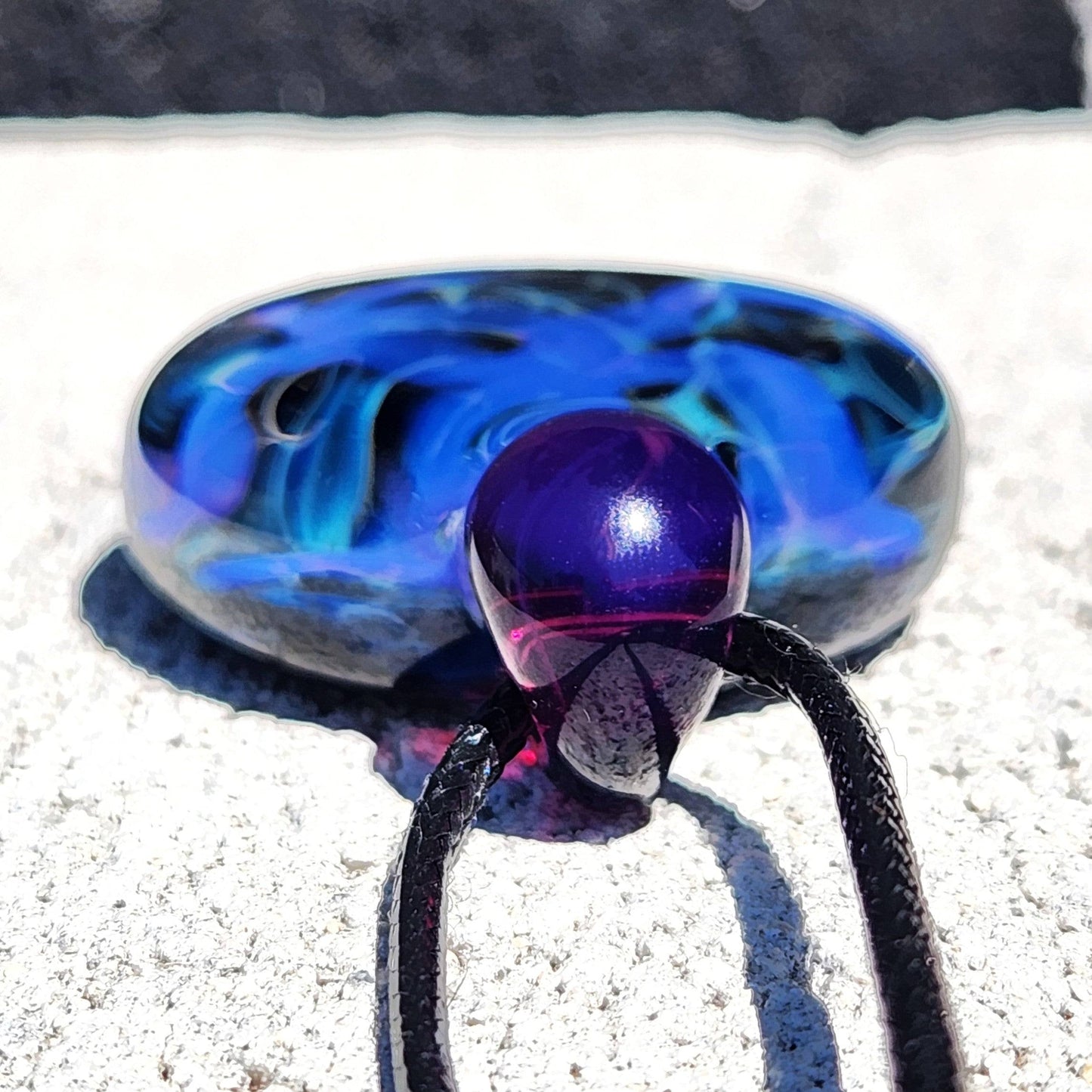 Close-up of purple loop on Handmade Blue Swirl Glass Pendant Necklace with detailed view of swirling blue glasswork.