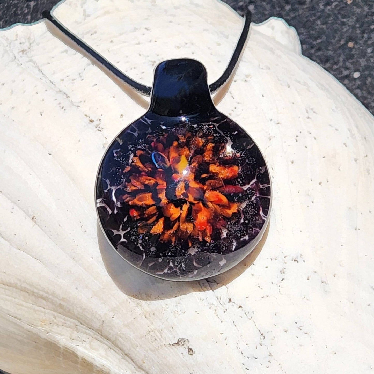 Handmade Fiery Glass Pendant featuring a glowing red-orange floral burst with crushed black glass, ideal for Halloween-themed accessories.