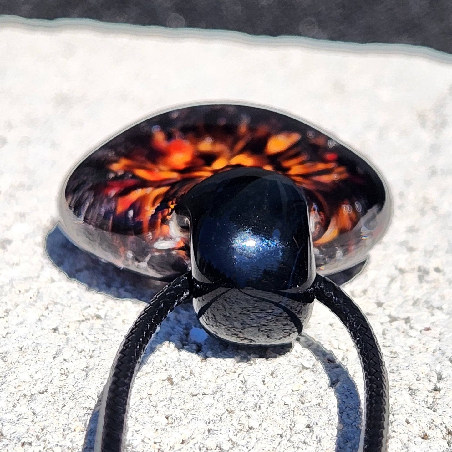 Bottom view of Fiery Glass Pendant showing glossy black loop and fiery bloom design, handcrafted Halloween-inspired glass jewelry.