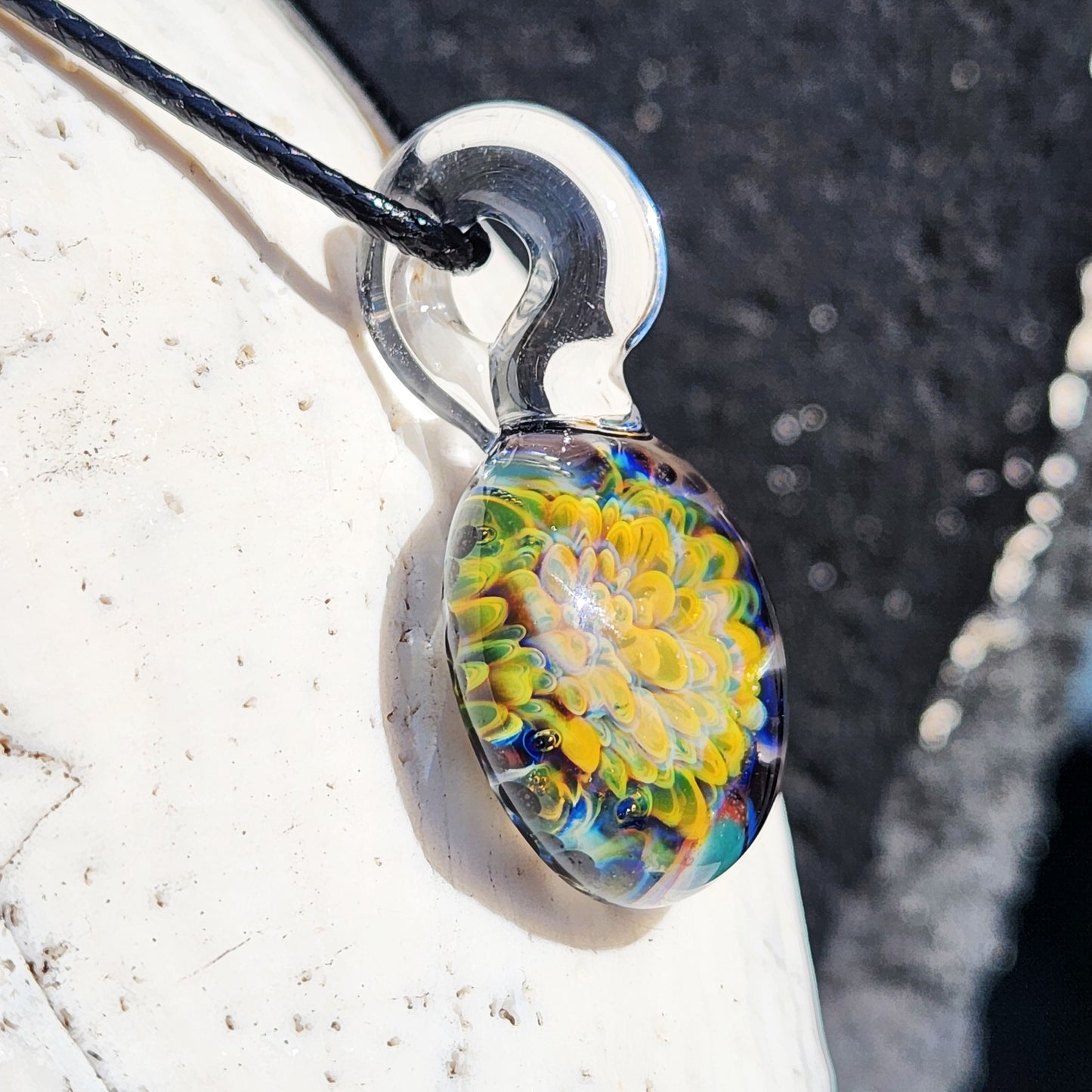 Unique green glass pendant necklace with intricate floral pattern, handcrafted and lightweight for everyday wear.