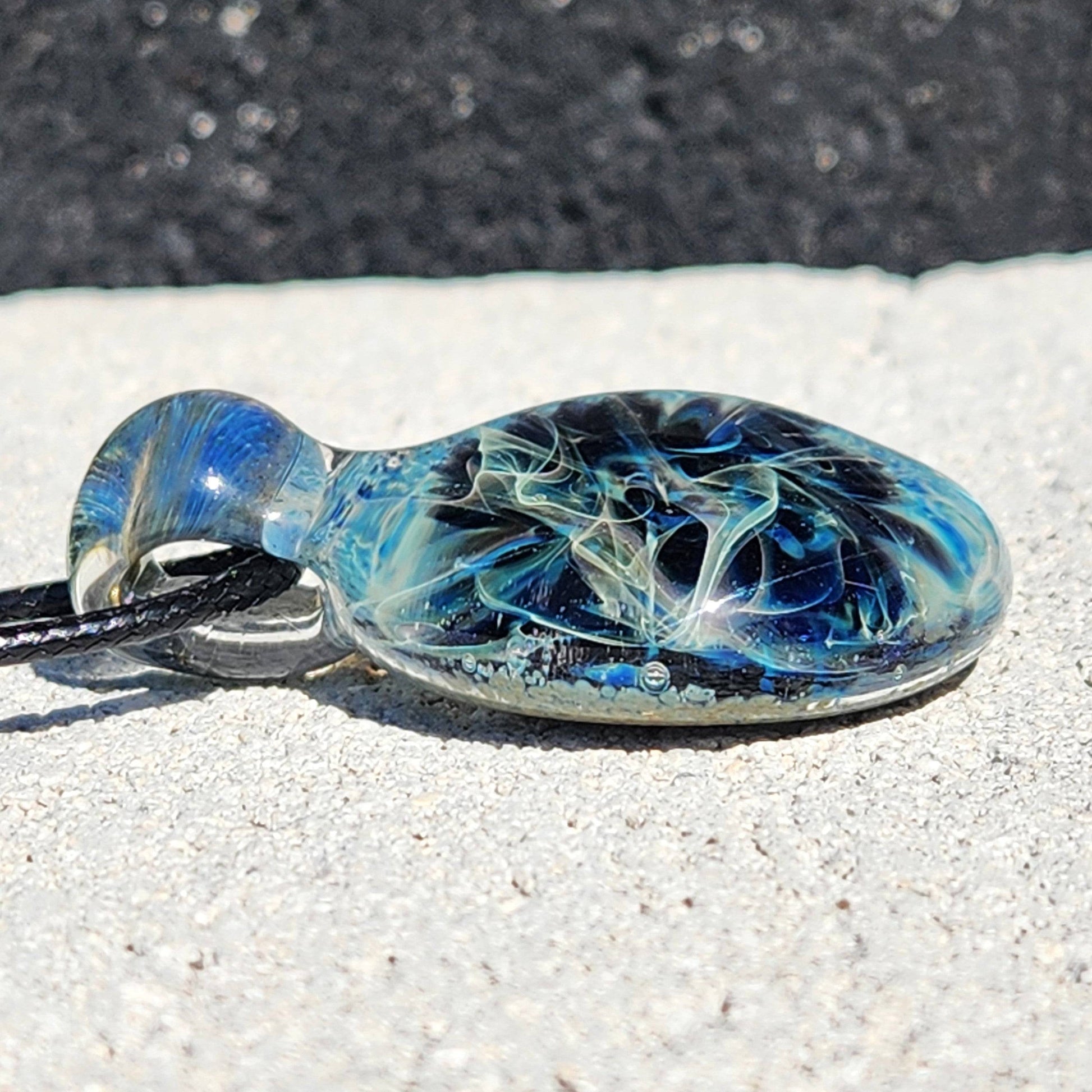 Side view of Handmade Pendant Necklace – Winter Scene Borosilicate Glass Pendant highlighting its domed shape and color depth.