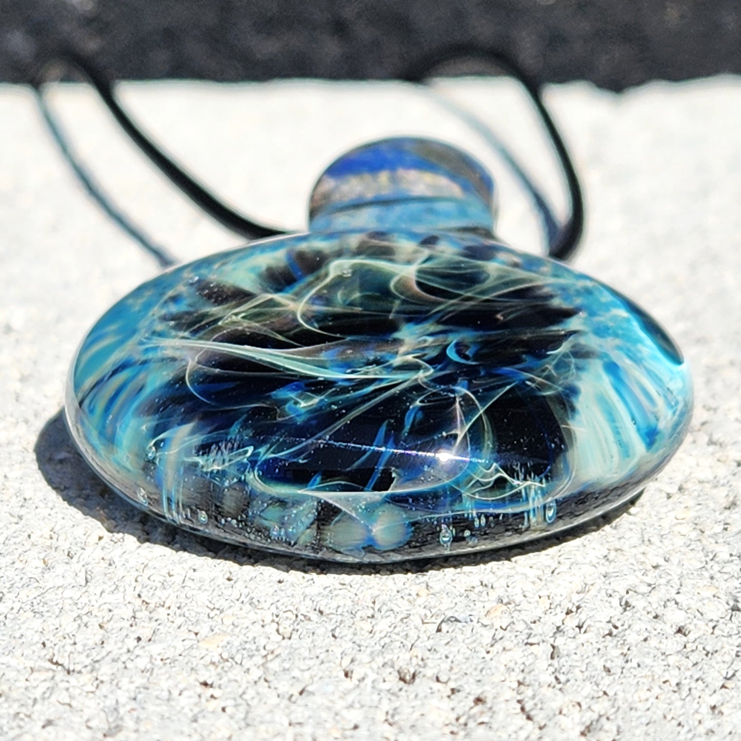 Bottom view of Handmade Pendant Necklace – Winter Scene Borosilicate Glass Pendant with layered blue and black glass effects.