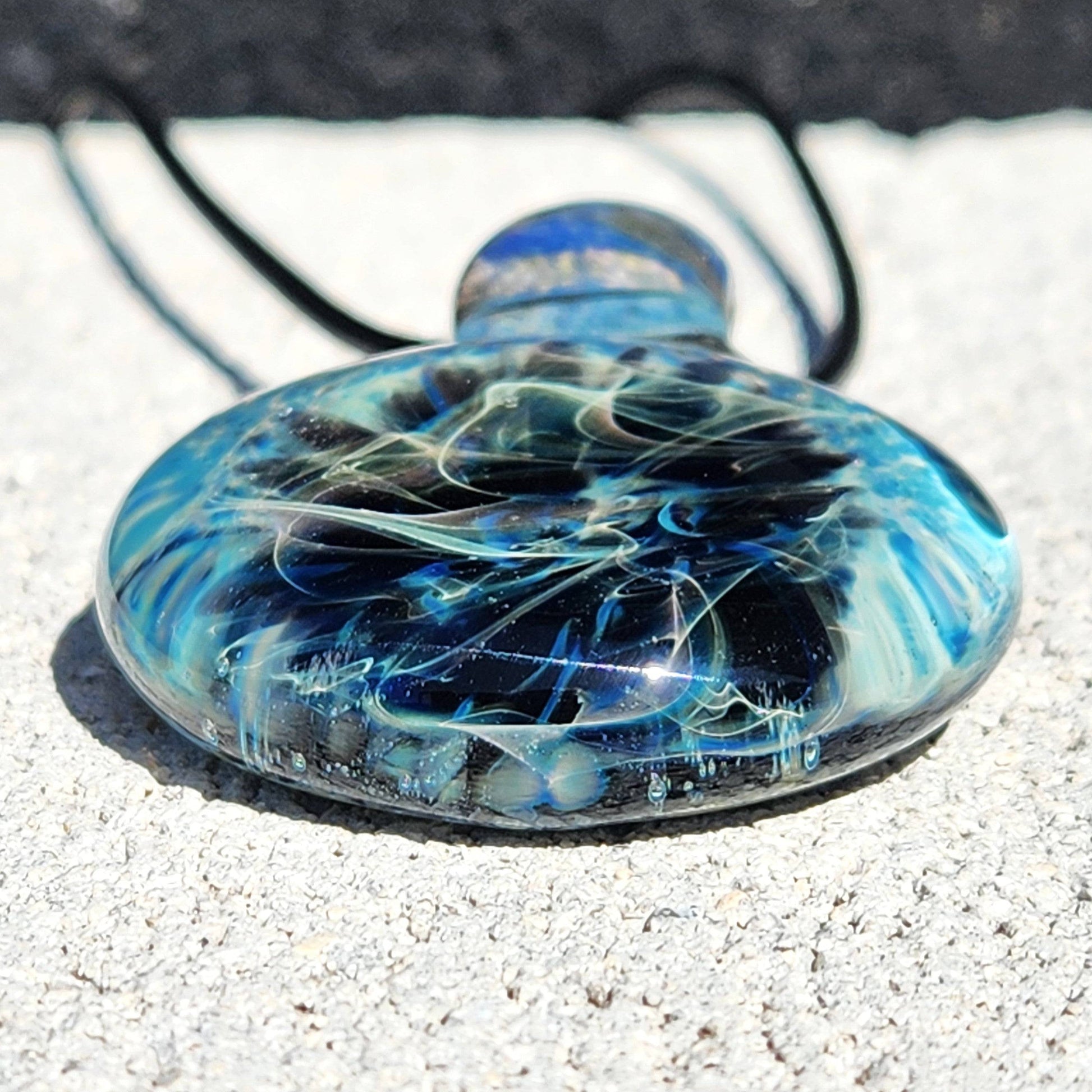 Bottom view of Handmade Pendant Necklace – Winter Scene Borosilicate Glass Pendant with layered blue and black glass effects.