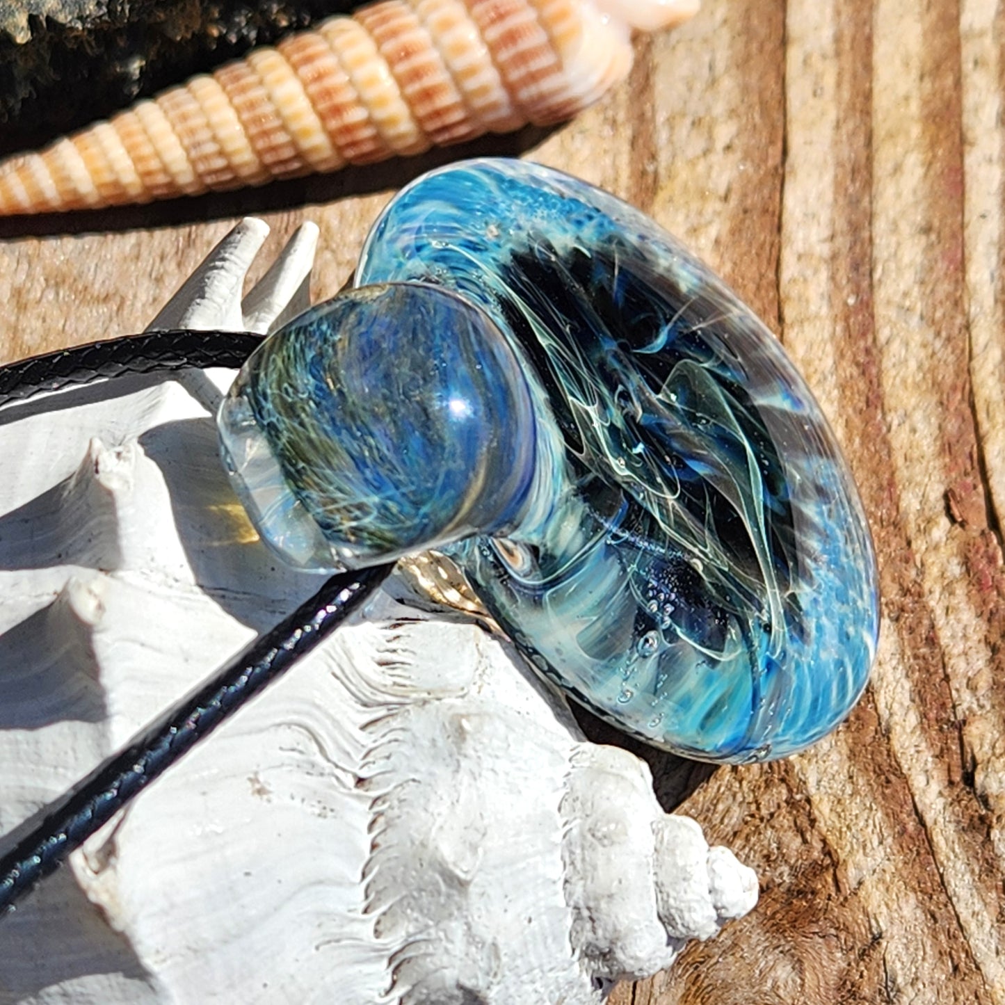 Top angle of Handmade Pendant Necklace – Winter Scene Borosilicate Glass Pendant emphasizing its loop and textured glasswork.