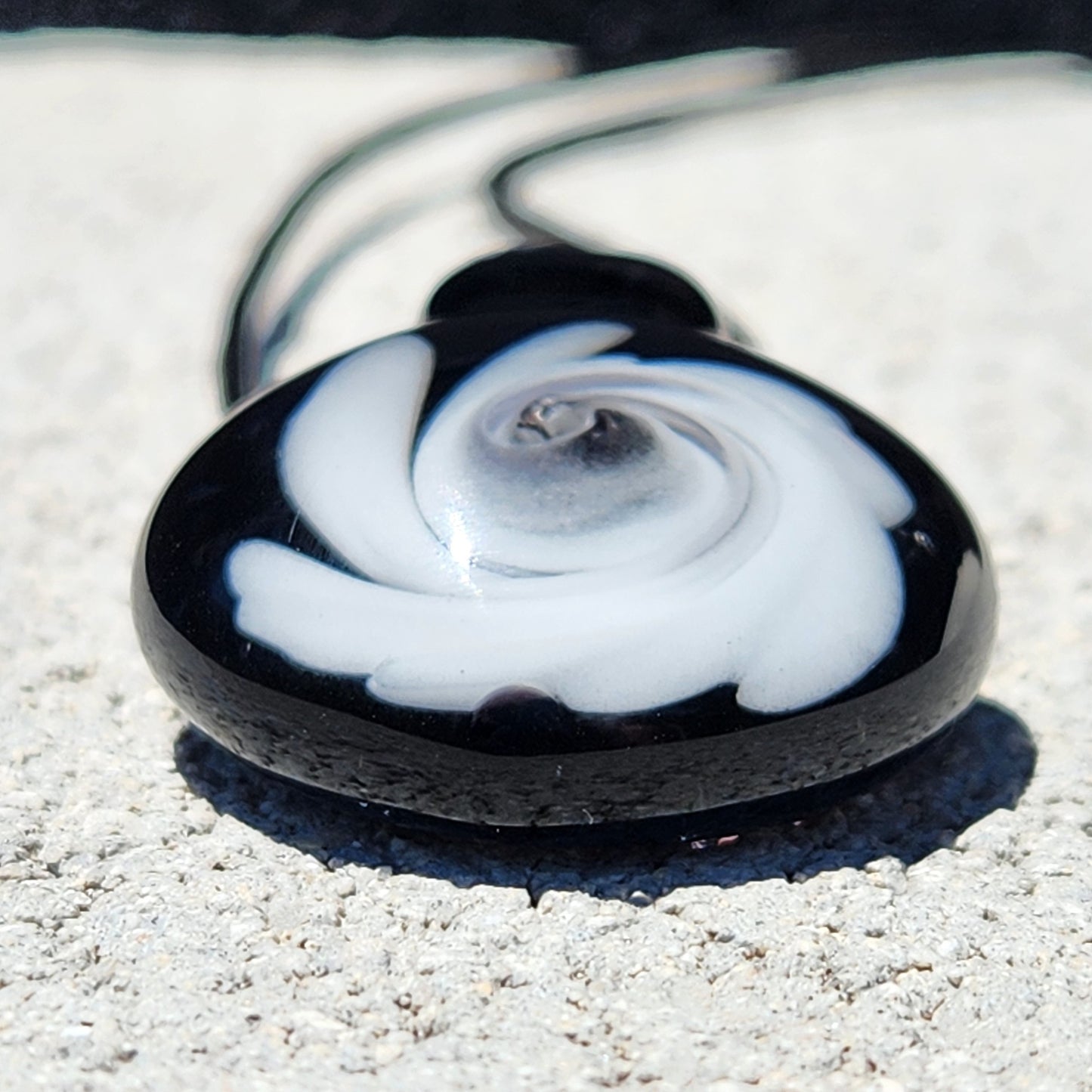 Close-up of Black and White Swirl Glass Pendant | Handmade Necklace Jewelry Gift highlighting the smooth, domed glass and intricate swirl detail.