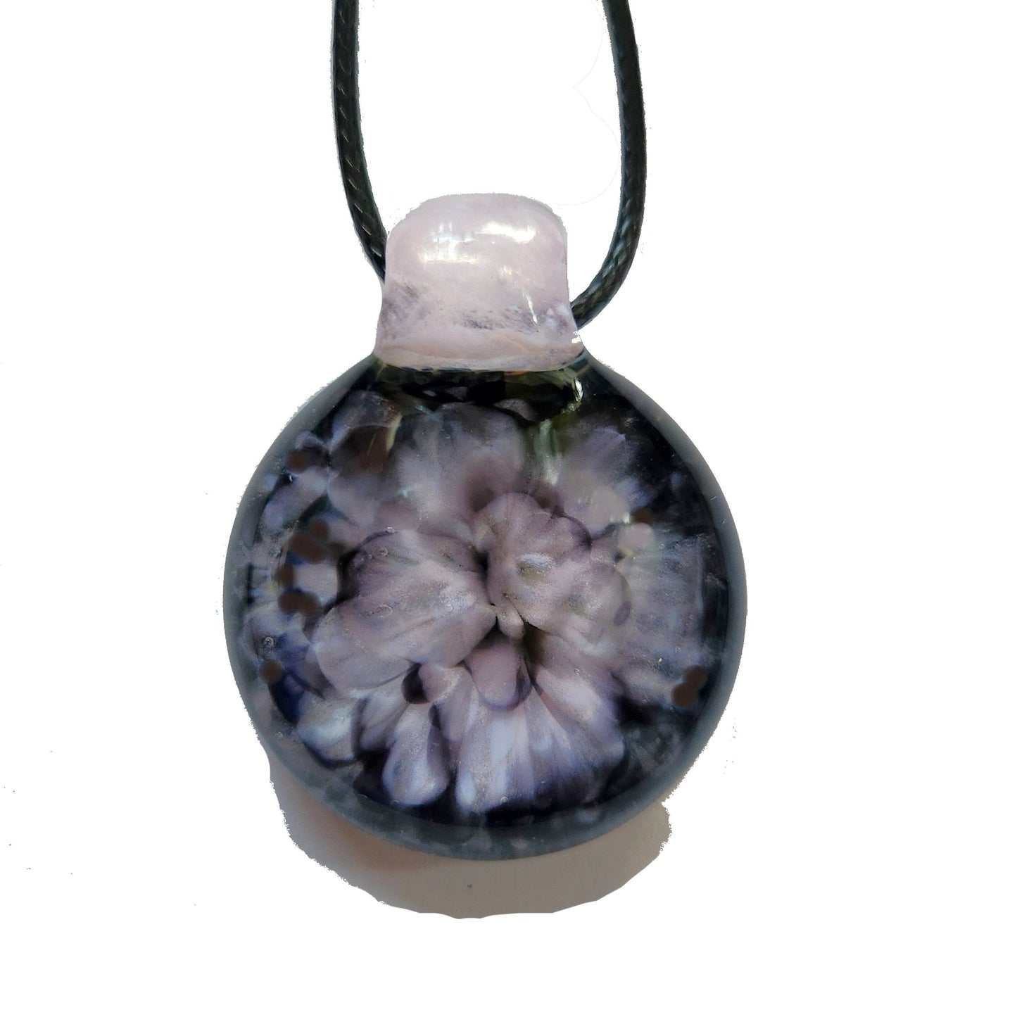 Isolated view of handmade pink flower pendant necklace with black cord, showcasing the floral crushed glass centerpiece.