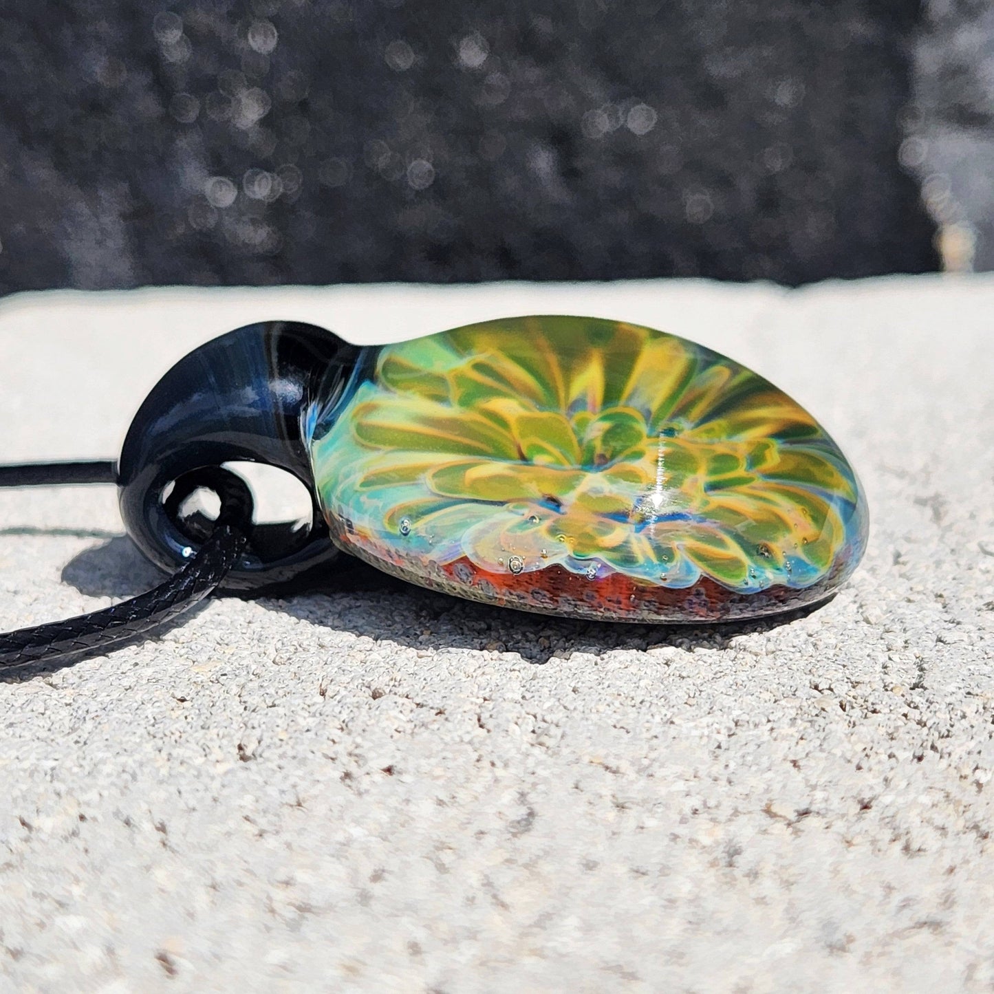Side profile of handmade glass pendant showing intricate yellow-green floral design. Unique necklace gift in jewelry pendants category.