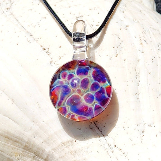 Unique purple & blue glass pendant with rainbow bubble dot design on black cord, handmade borosilicate jewelry for boho fashion lovers.