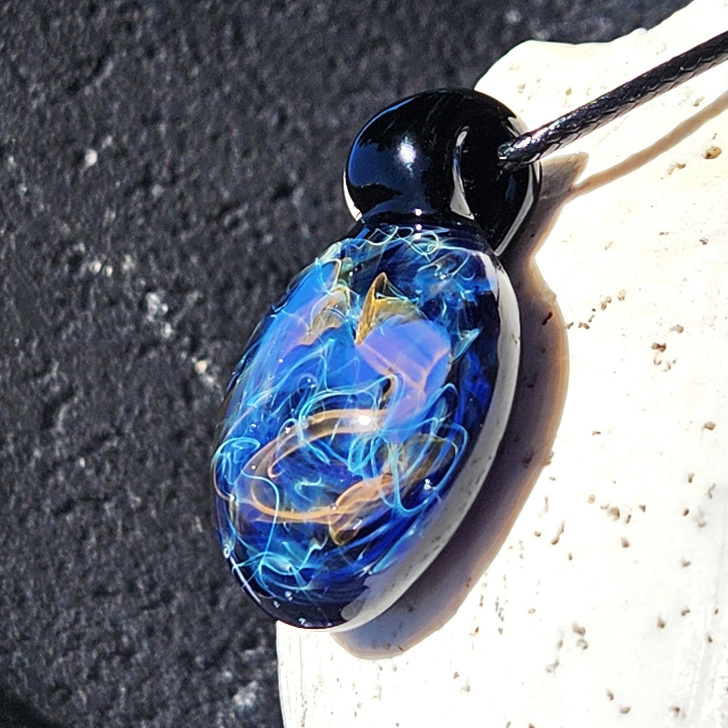 Side view of Handmade Glass Pendant – Unique Gold & Silver Fumed Black Necklace showing intricate fumed glass details.