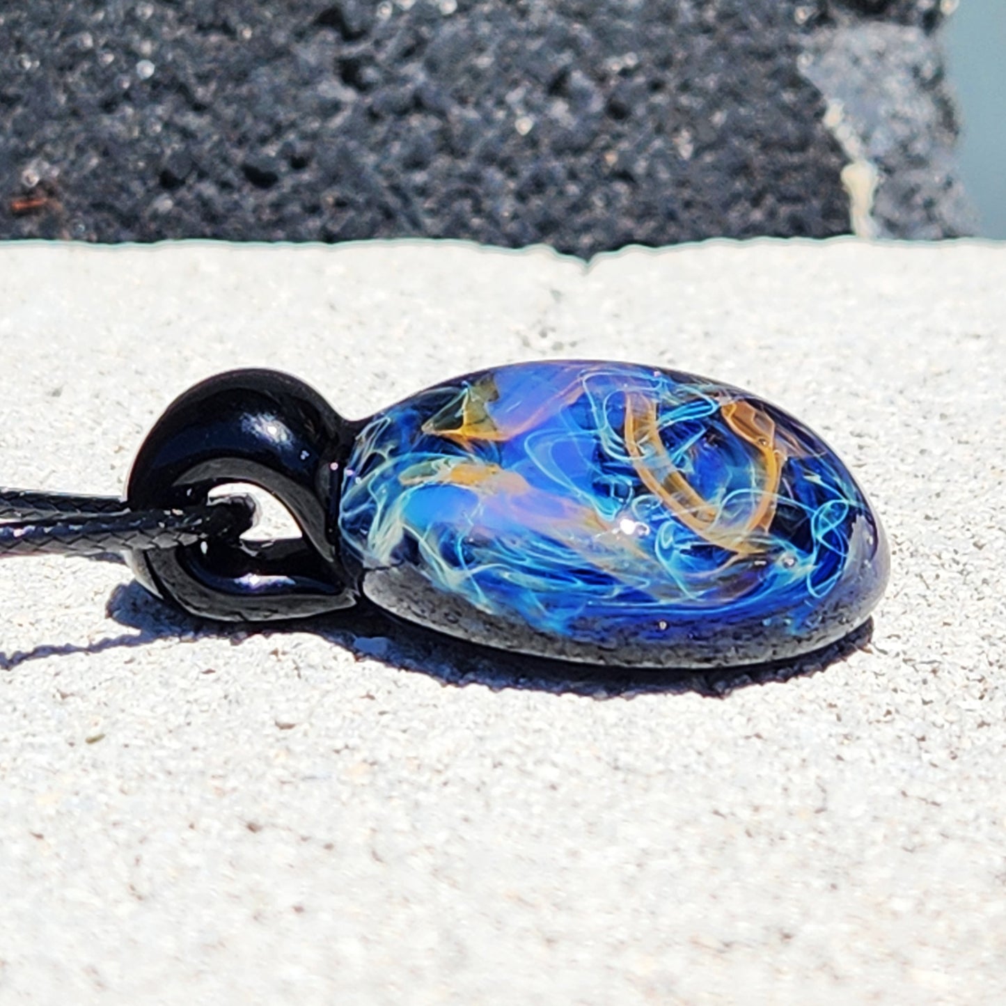 Close-up of Handmade Glass Pendant – Unique Gold & Silver Fumed Black Necklace showing detailed swirling design.