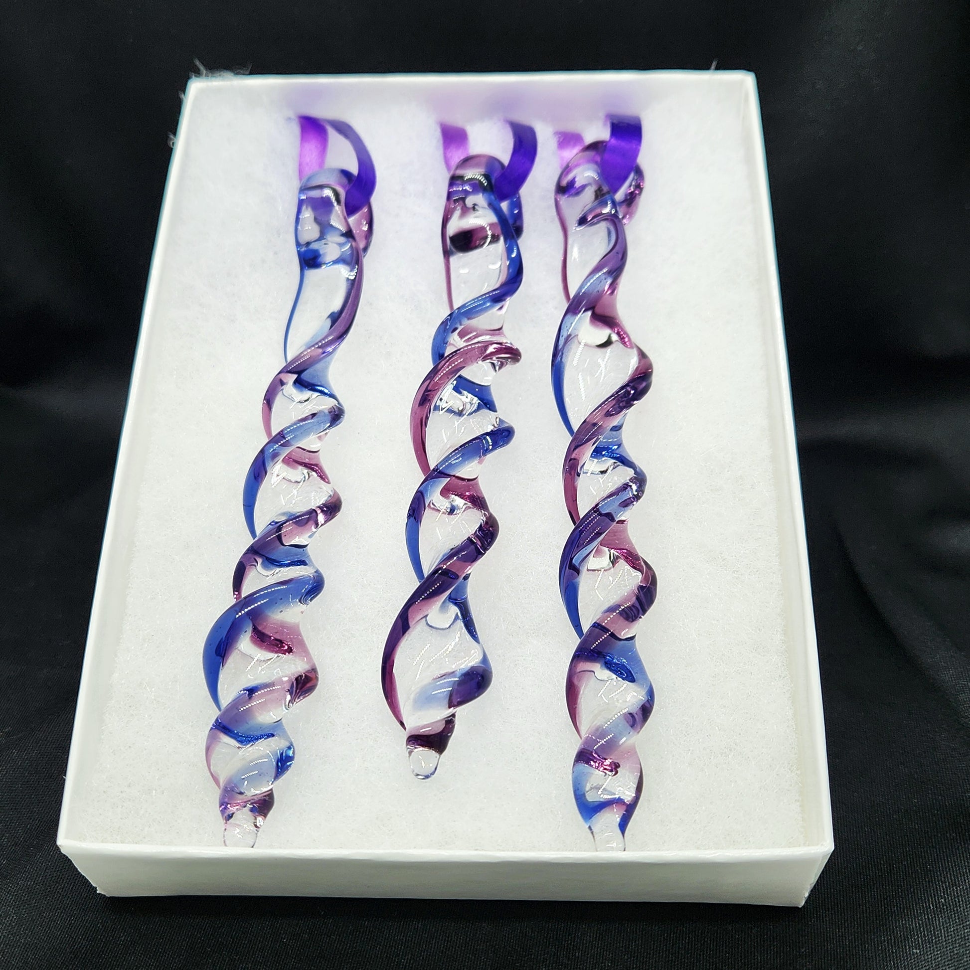 Gift box with 3 handmade blue and purple glass Christmas ornaments featuring twisted icicle shapes, ideal for holiday or garden decor.