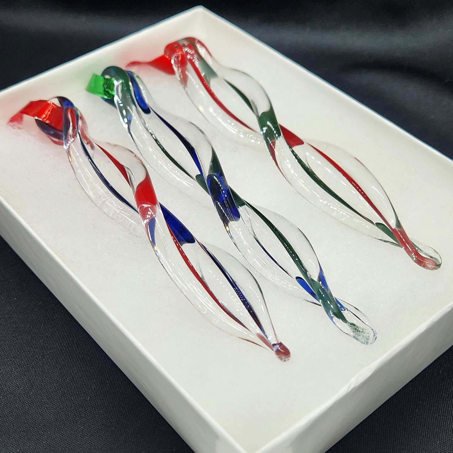 Gift box with 3 handmade glass ornaments in red, green, and blue swirls. Beautifully packaged for easy holiday gift giving.
