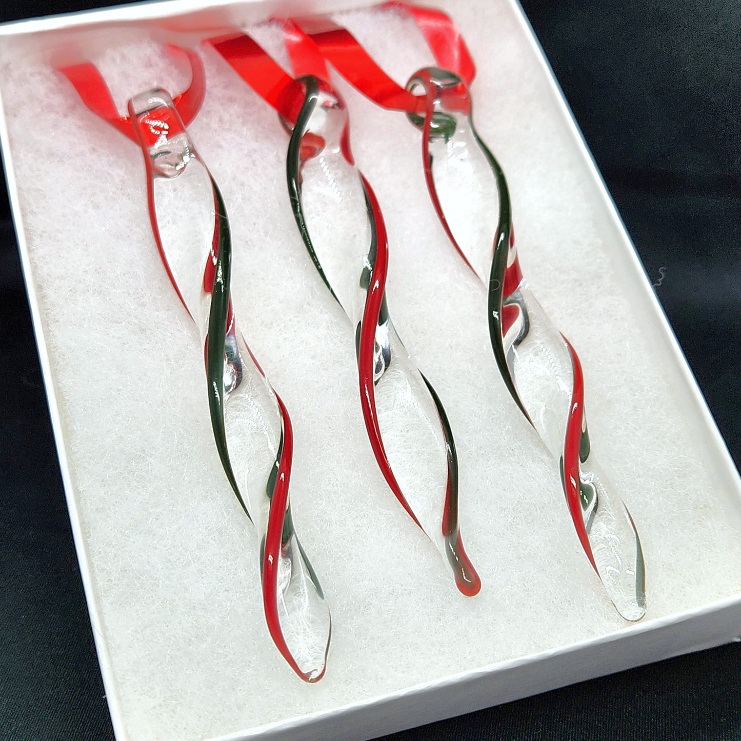 Unique handmade glass holiday ornaments in red and green swirl design, perfect for Christmas decor or gifts. Set of 3 icicle-shaped ornaments in gift box.