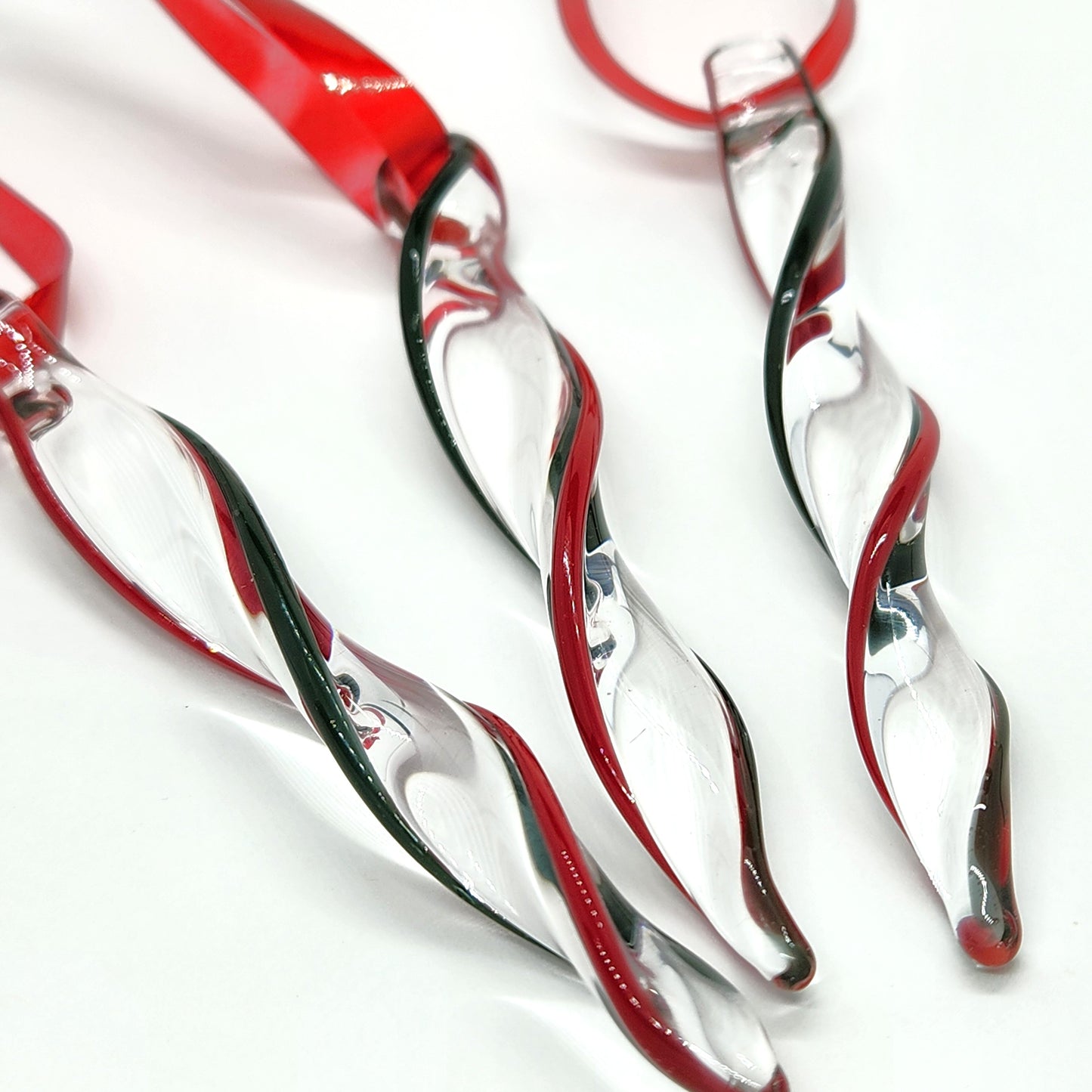 Unique handmade glass holiday ornaments in red and green twisted icicle design, perfect for Christmas decor and festive gifts.