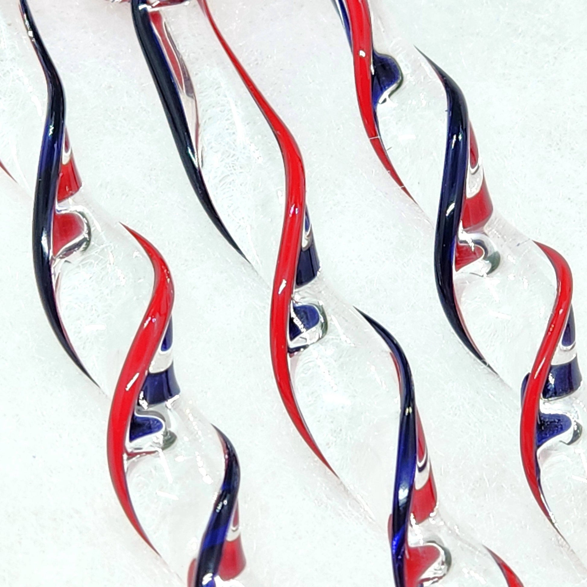 Detailed view of Red & Blue Glass Christmas Ornaments showing the clear glass with red and blue spiral accents, ideal for festive decorating.