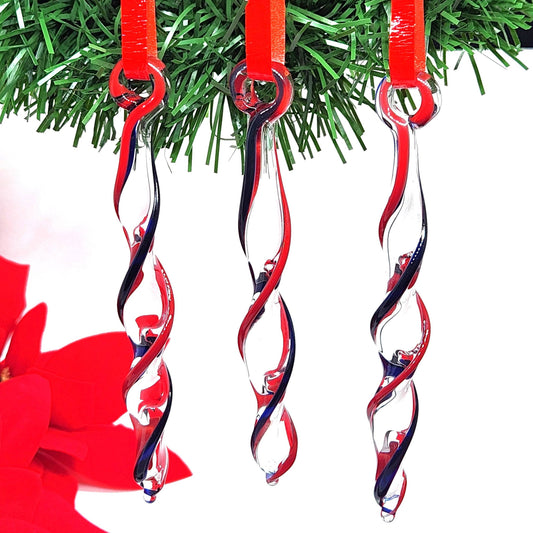 Red & Blue Glass Christmas Ornaments hanging on a tree, handmade icicle design with twisted red and blue stripes for festive holiday decor.