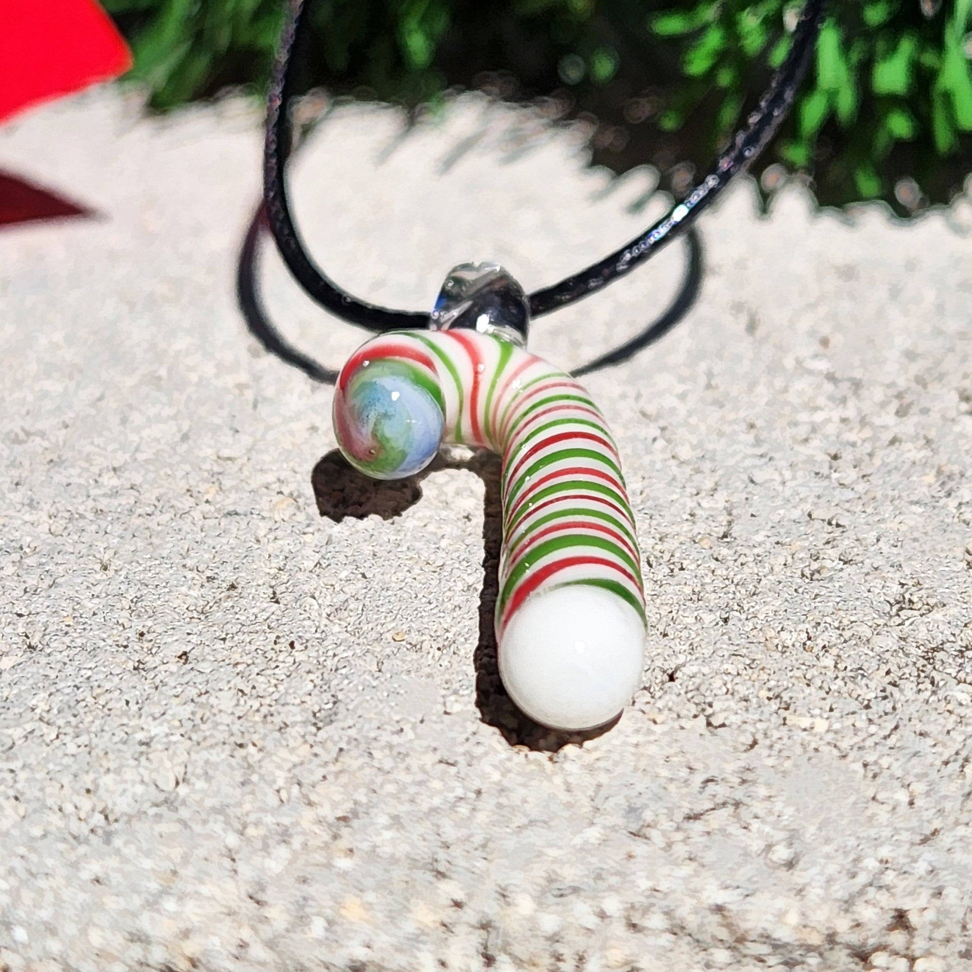 Front view of handmade glass candy cane pendant with vibrant holiday colors, ideal for Christmas jewelry gift ideas.