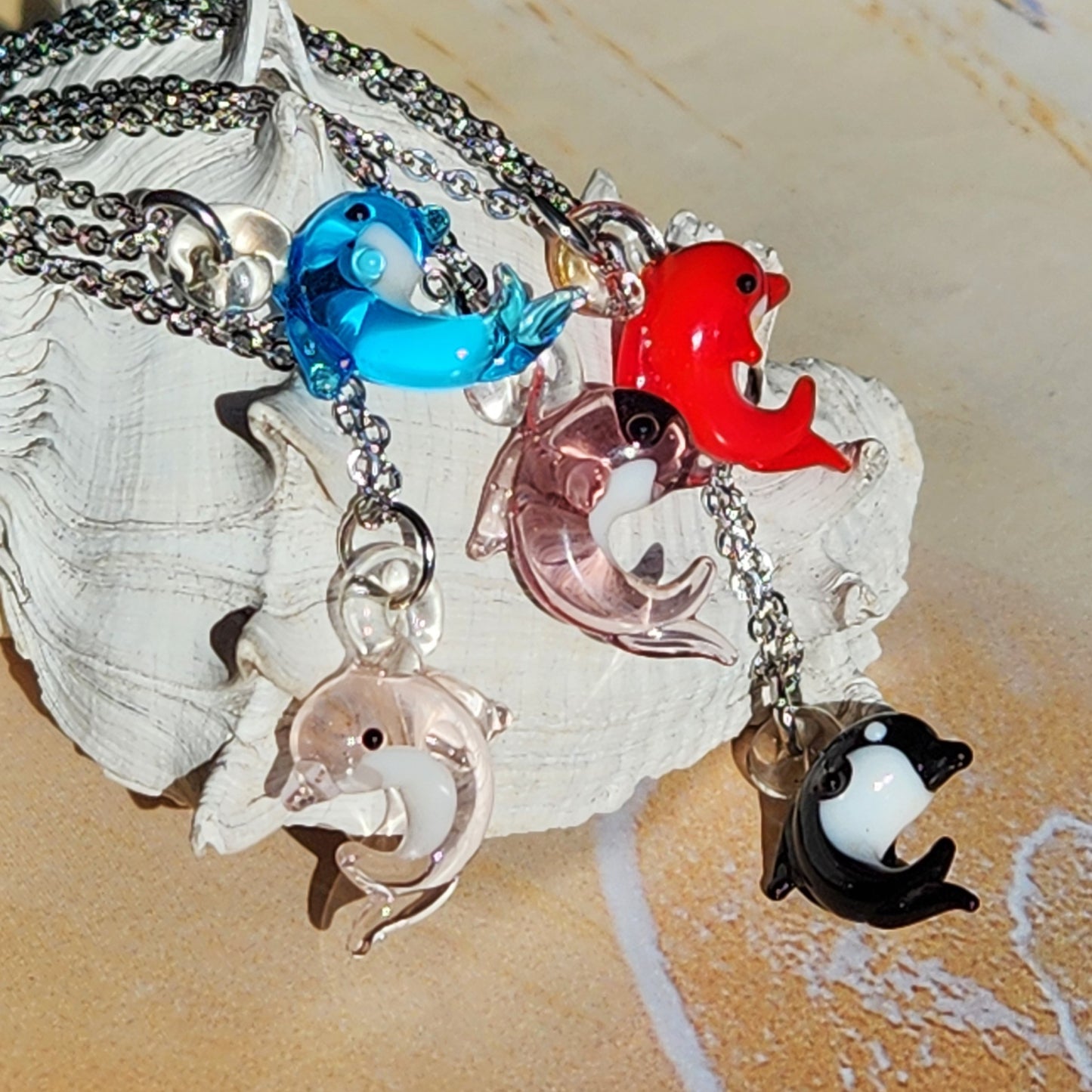 Assorted Tiny Dolphin Glass Necklaces Displayed