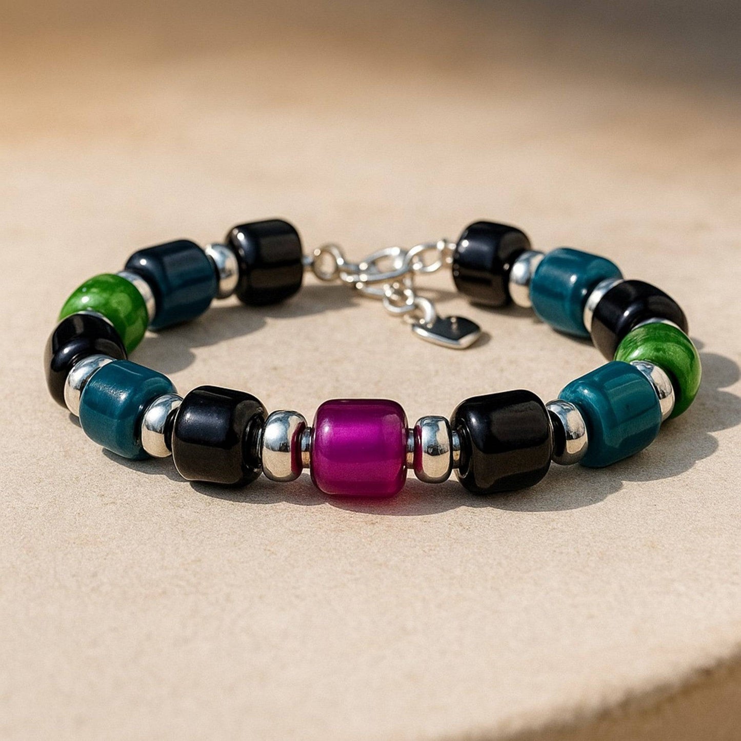 Boho Glass Beaded Bracelet with purple centerpiece bead and adjustable clasp, laid flat on a neutral background.