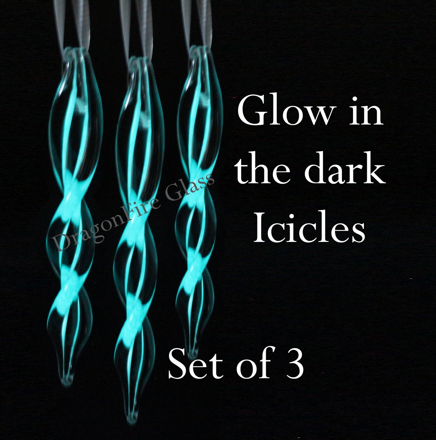 Set of three glow-in-the-dark glass icicle ornaments glowing blue in the dark. Handmade Christmas keepsakes perfect for holiday gifts or decor.