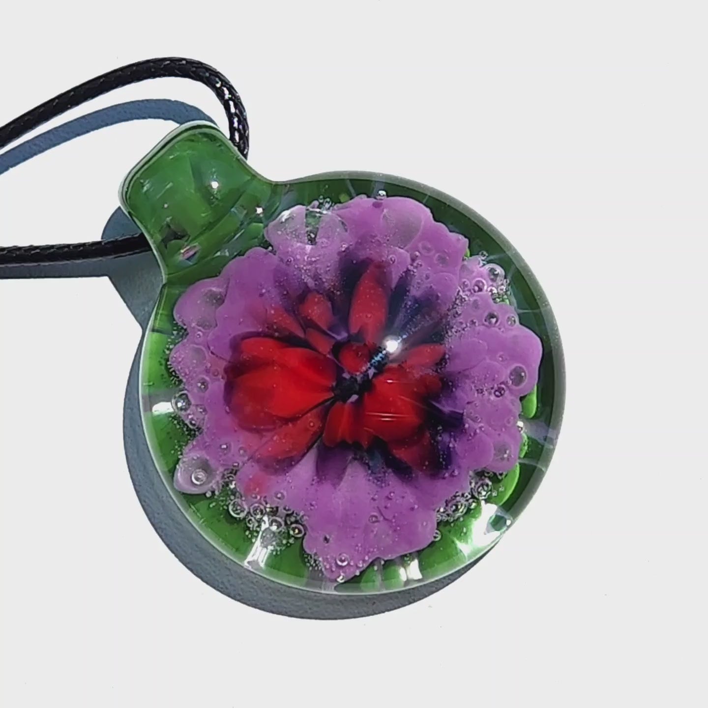 Large Heady Glass Pendant Necklace with intricate red, black, and purple flower design in green glass. One-of-a-kind handmade jewelry art piece.