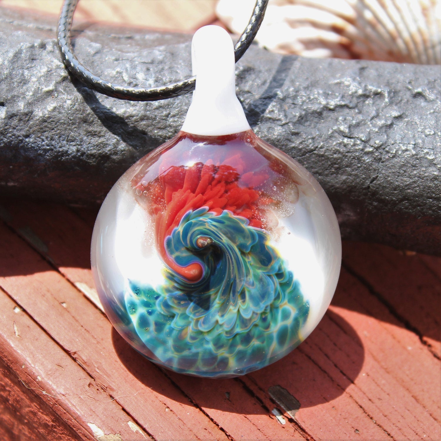 Psychedelic swirl glass pendant with vibrant red, blue, and green colors.