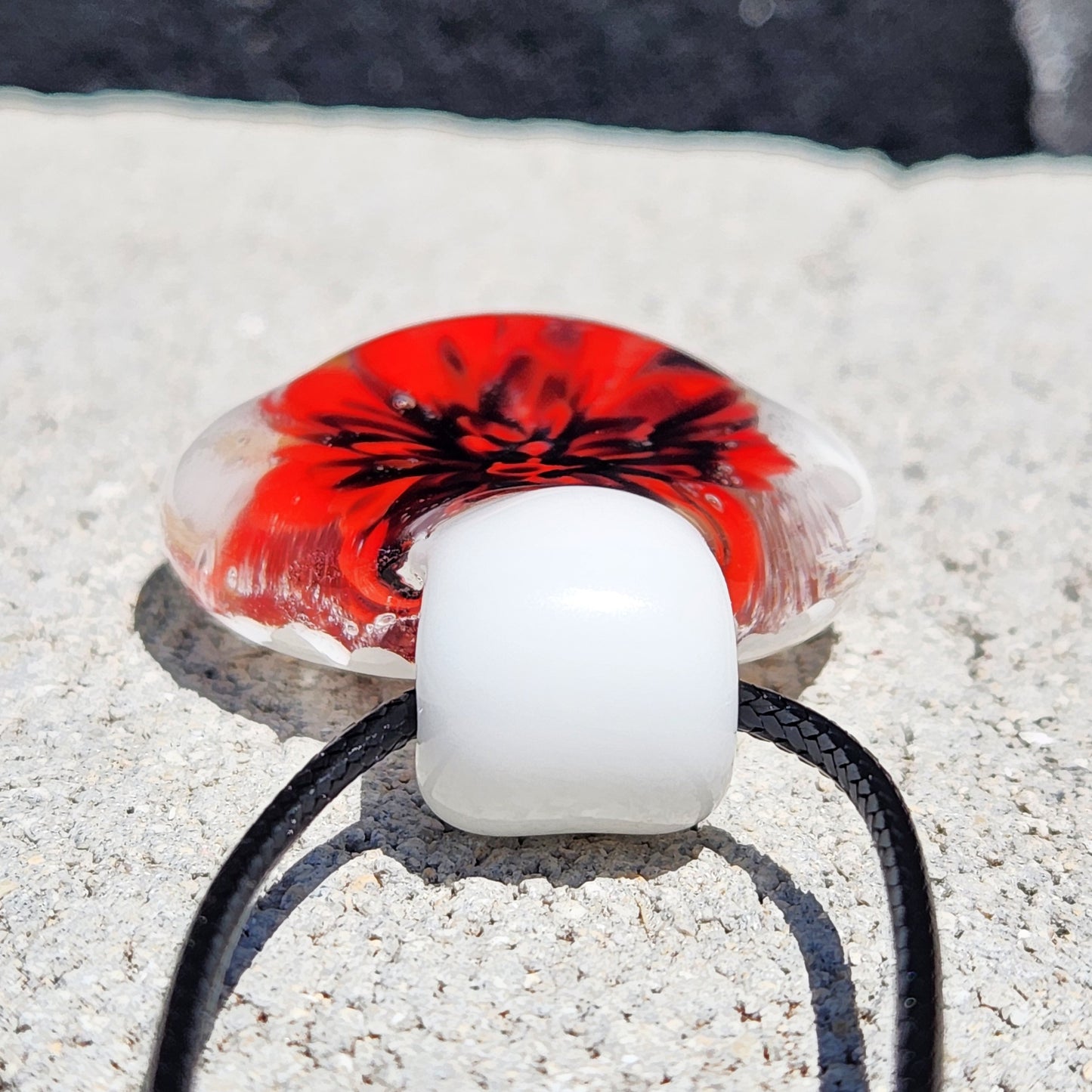 Back view of Handmade Glass Pendant Necklace with white loop and black cord, showing pendant thickness and finish.