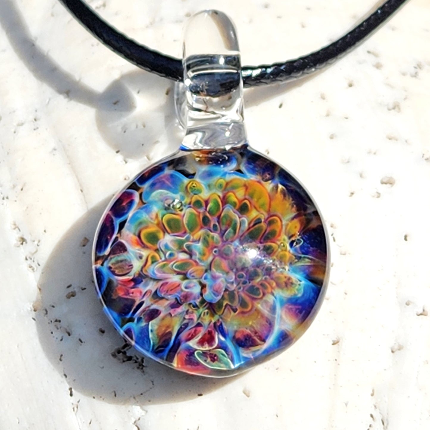 Ocean Reef Glass Pendant Necklace with colorful reef design in blue, green, and red tones, displayed on a white shell for jewelry detail view.