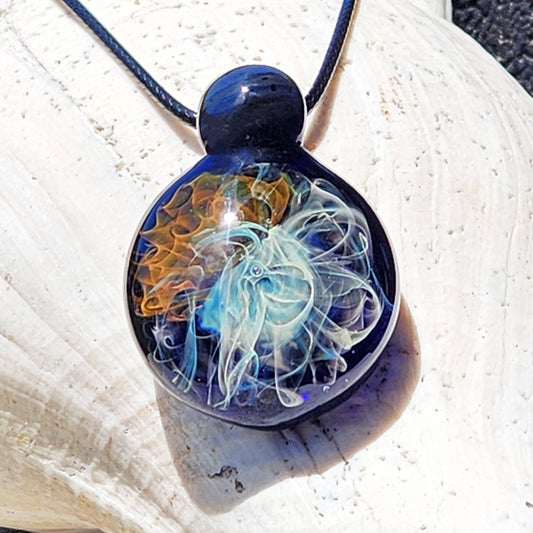 Gold & Silver Fumed Glass Pendant Necklace with swirling galaxy design, handblown in the USA. Features blue, gold, and silver accents on black cord.