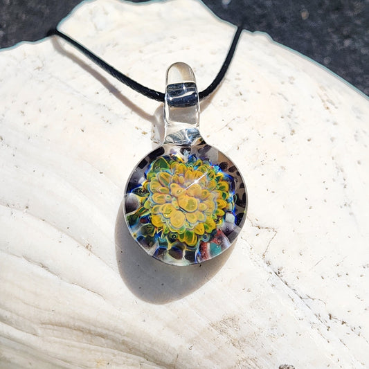 Green glass pendant necklace featuring a vibrant yellow and green floral design, handmade and one of a kind jewelry piece.