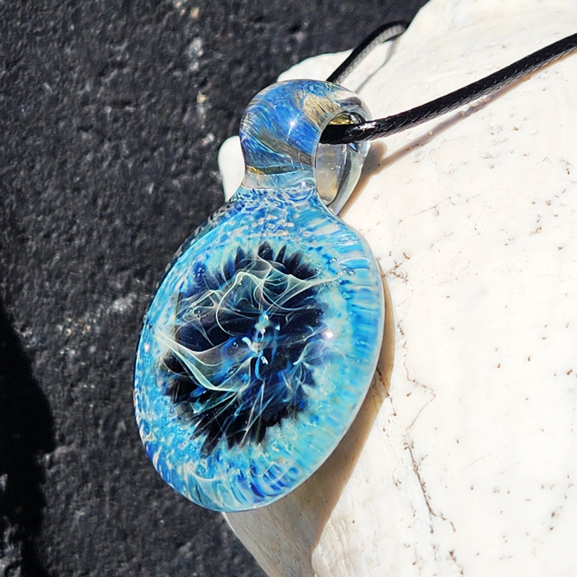 Close-up of Handmade Pendant Necklace – Winter Scene Borosilicate Glass Pendant showing intricate silver and blue glasswork.