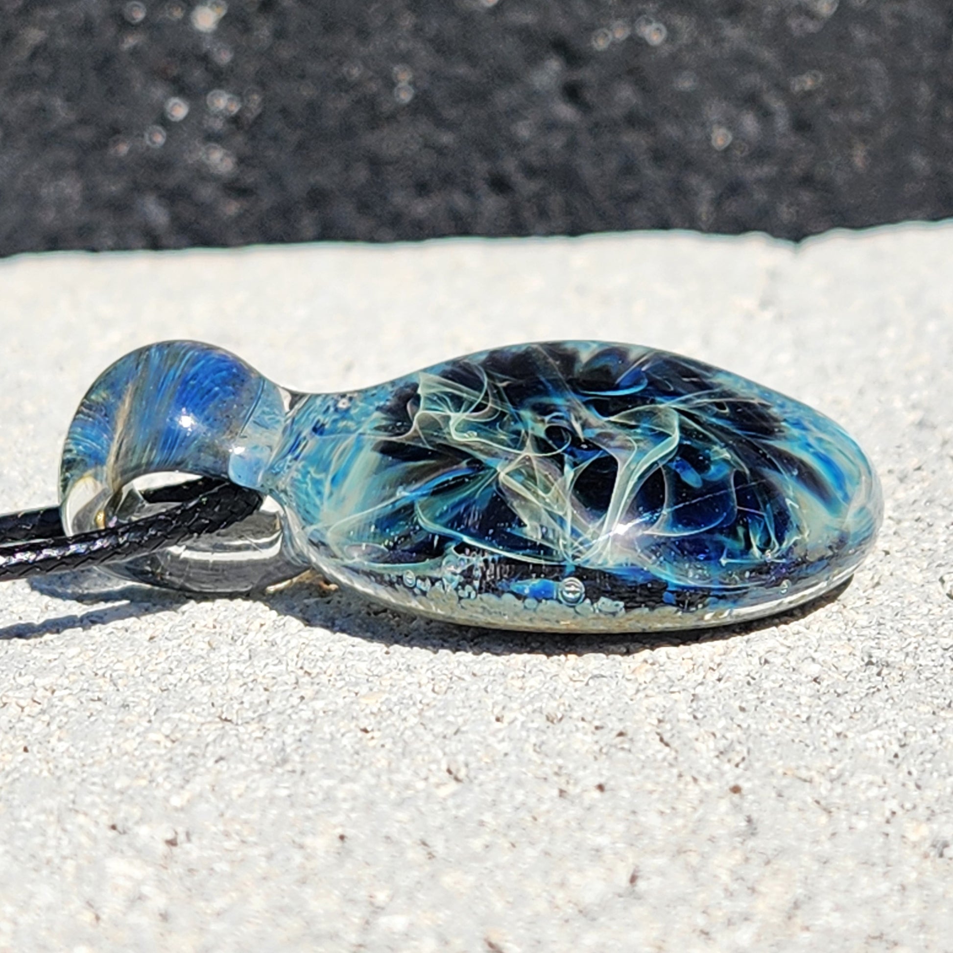 Side view of Handmade Pendant Necklace – Winter Scene Borosilicate Glass Pendant highlighting its domed shape and color depth.