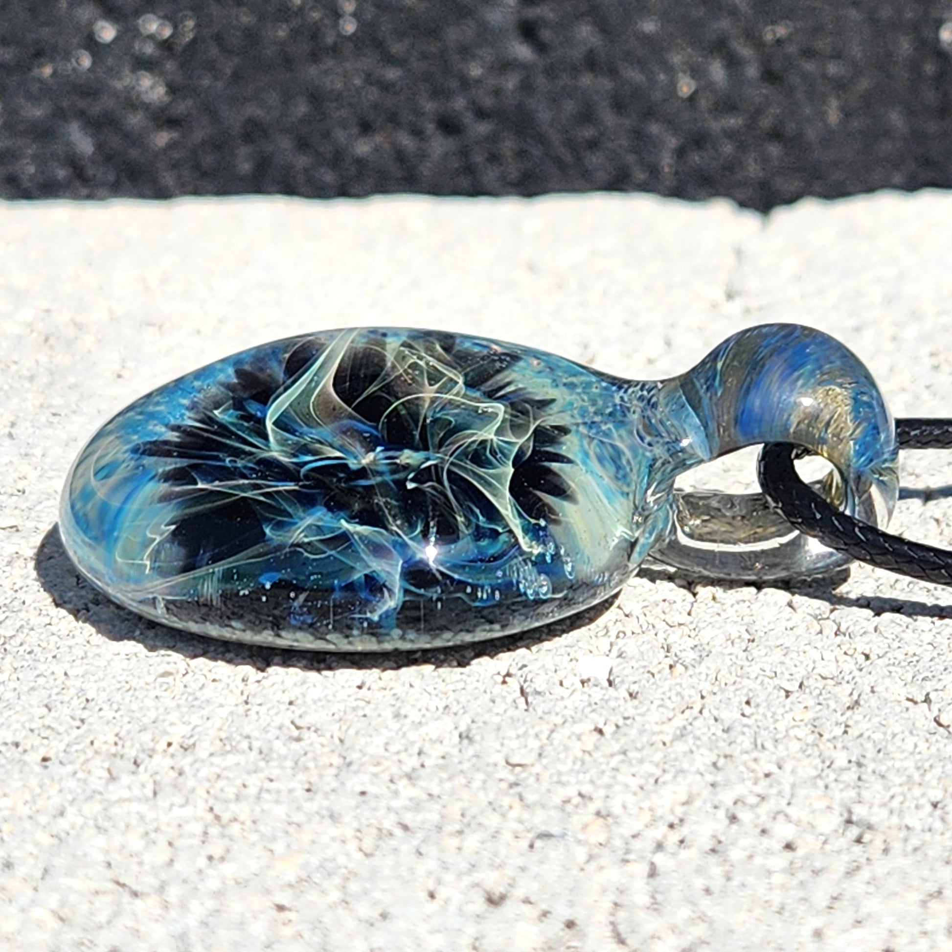 Flat view of Handmade Pendant Necklace – Winter Scene Borosilicate Glass Pendant showing detailed silver and blue color patterns.