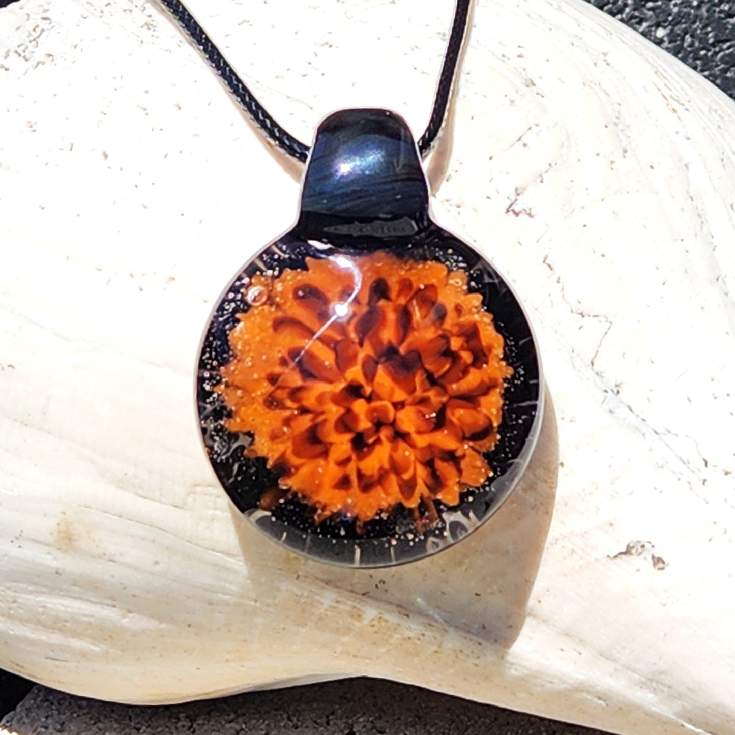 Fiery Glass Pendant Necklace with vivid orange and red flame bloom design, handmade with black glass accents. Unique Halloween-inspired jewelry gift.