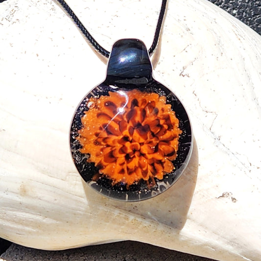 Fiery Glass Pendant Necklace with vivid orange and red flame bloom design, handmade with black glass accents. Unique Halloween-inspired jewelry gift.