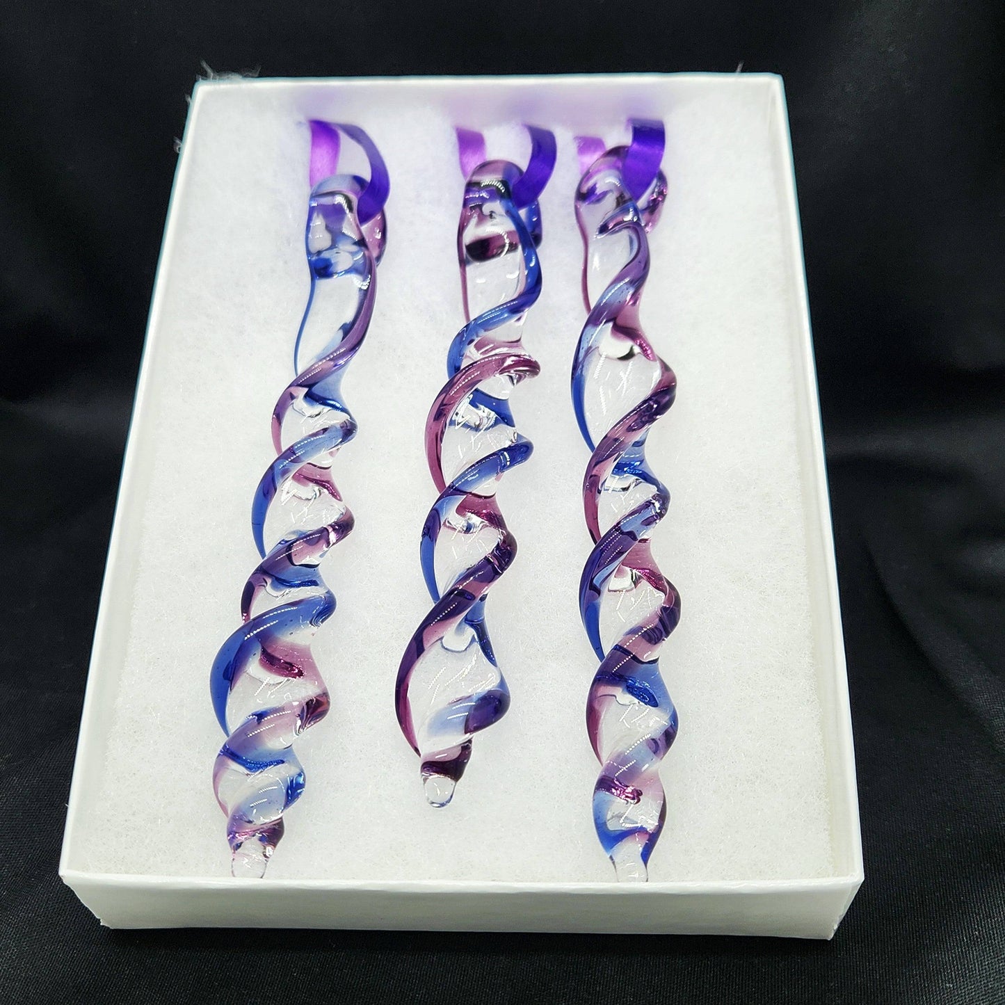 Gift box with 3 handmade blue and purple glass Christmas ornaments featuring twisted icicle shapes, ideal for holiday or garden decor.