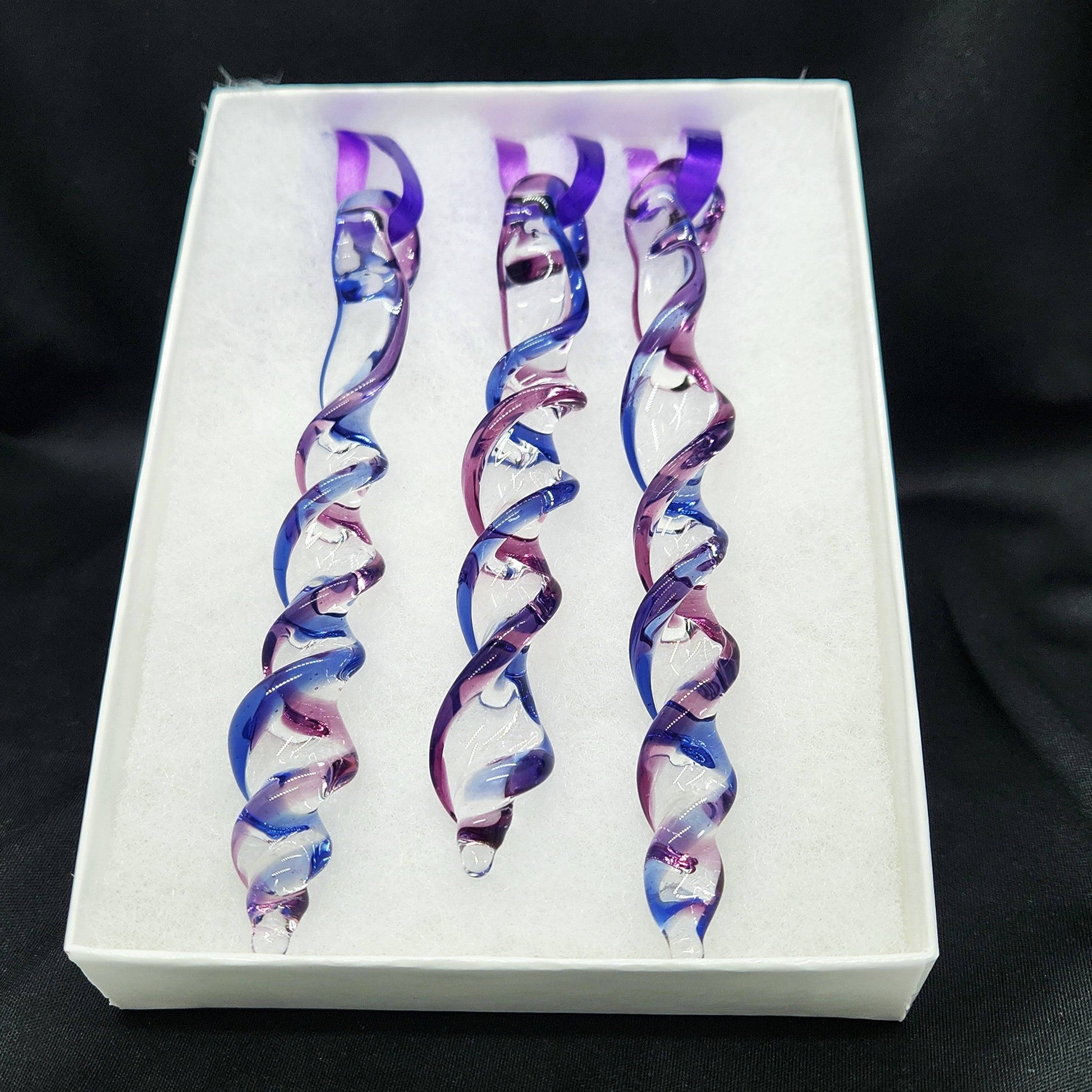 Gift box with 3 handmade blue and purple glass Christmas ornaments featuring twisted icicle shapes, ideal for holiday or garden decor.