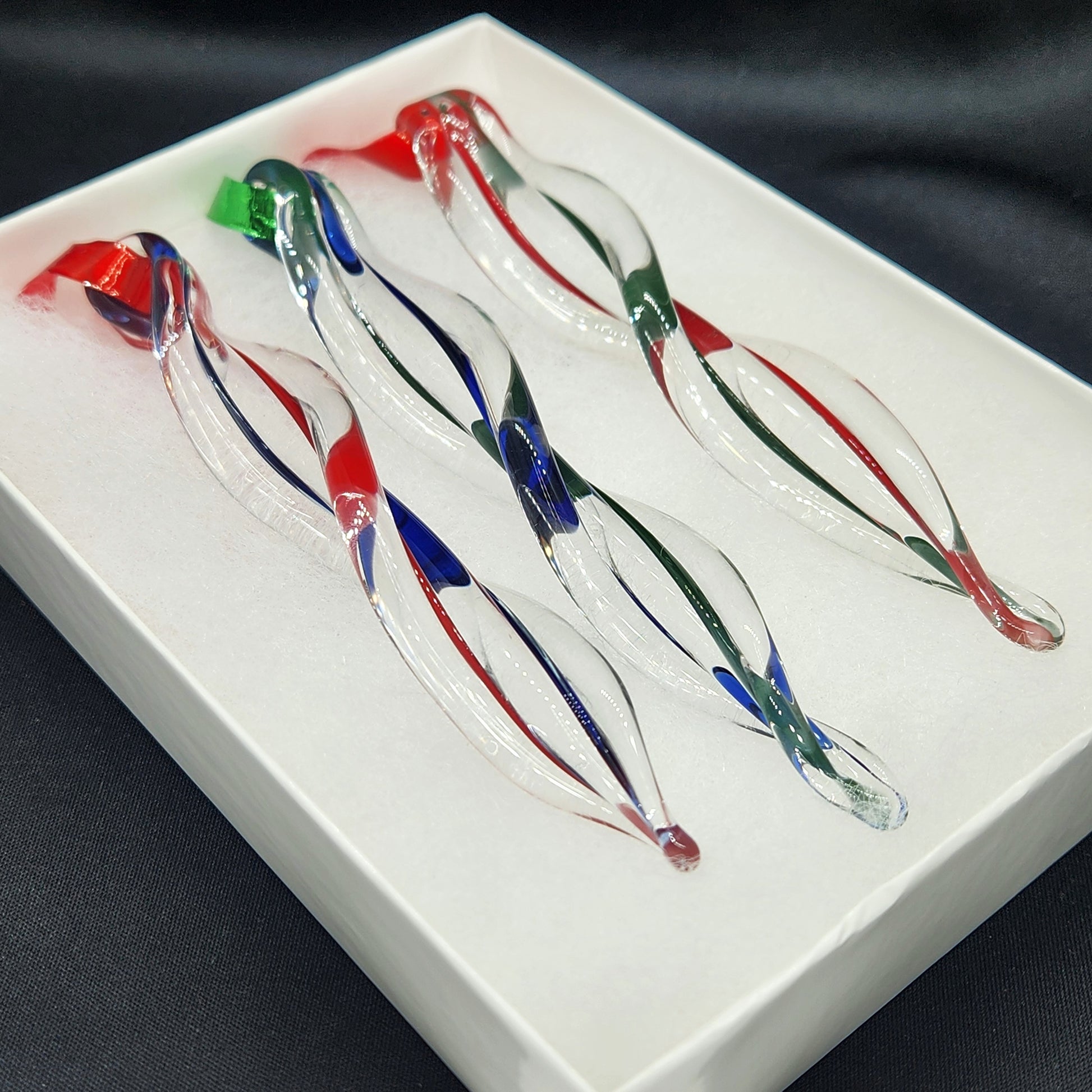 Gift box with 3 handmade glass ornaments in red, green, and blue swirls. Beautifully packaged for easy holiday gift giving.
