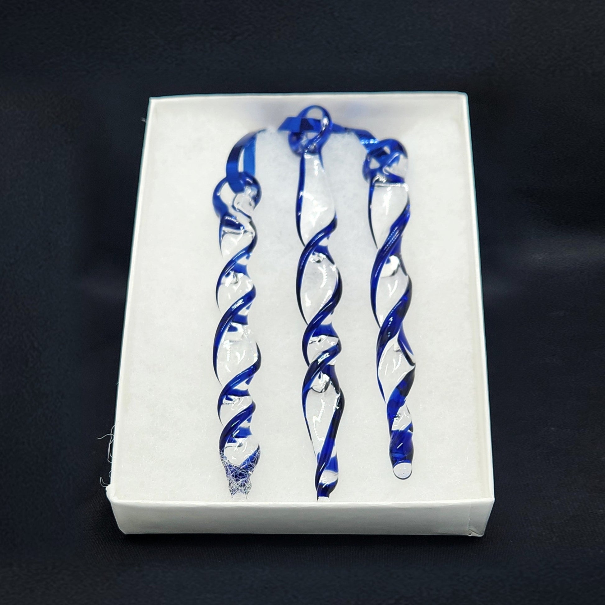 Handmade glass Christmas decoration set featuring three blue and clear twisted icicle ornaments in a white gift box. Ideal for holiday trees or garden décor.