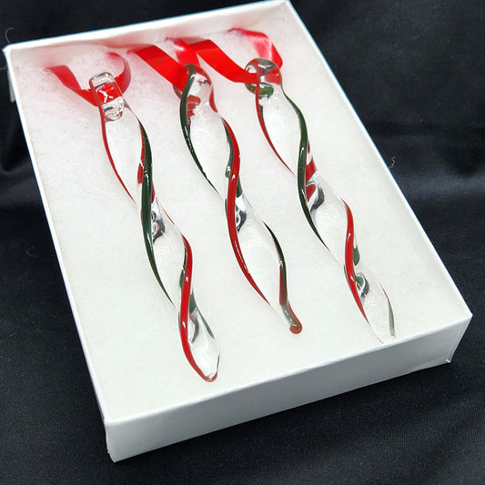 Unique handmade glass holiday ornaments in red and green swirl icicle design, perfect for Christmas tree decor or festive gift sets.