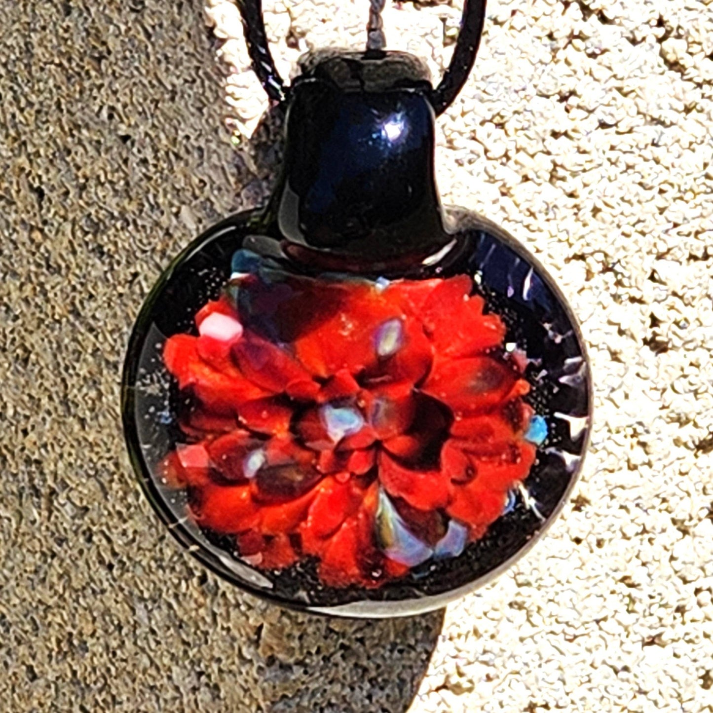 Radiant Red Glass Pendant Necklace featuring a vibrant red floral design, handmade from borosilicate glass. Unique jewelry gift in blown glass style.